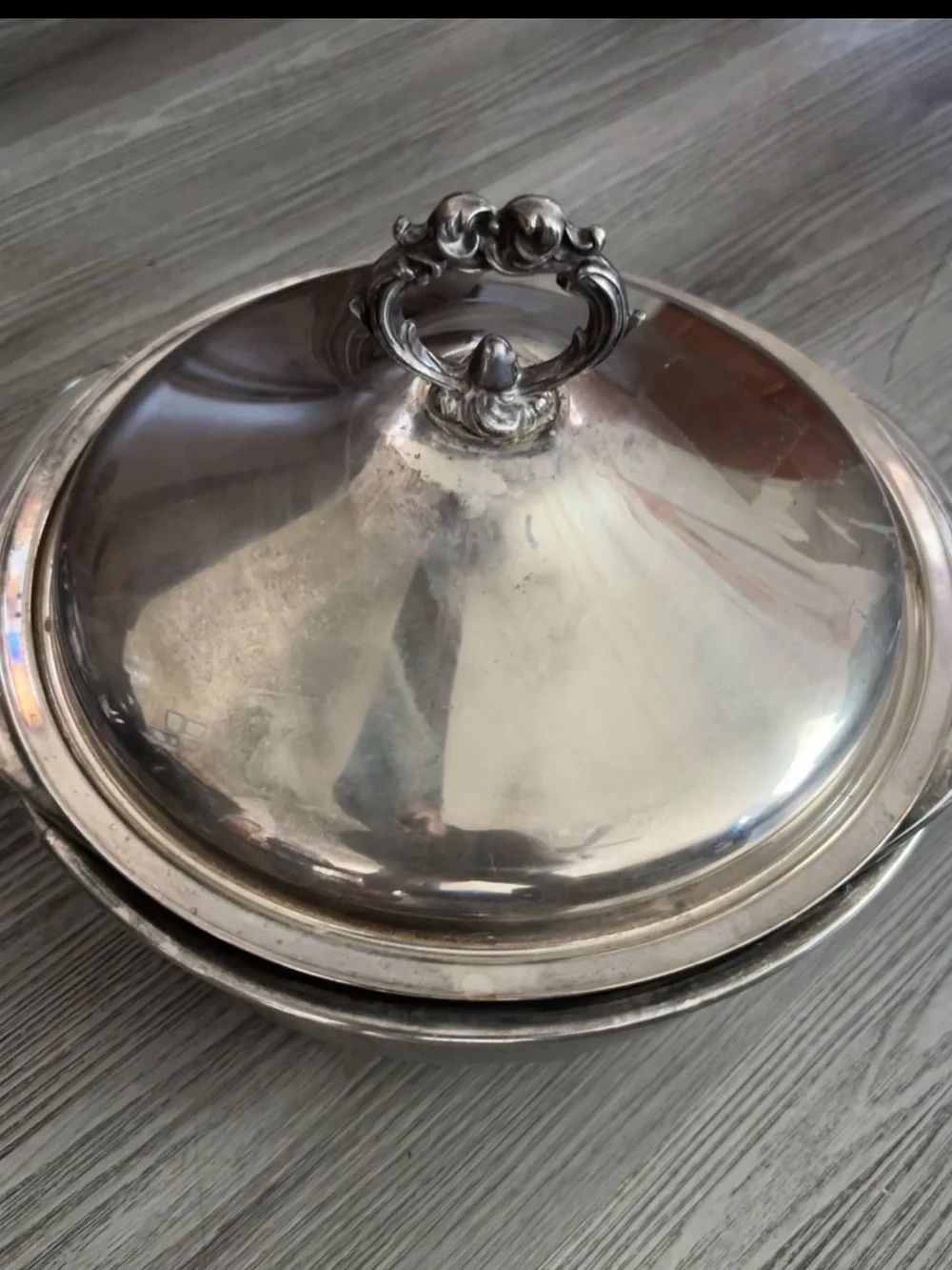 Pyrex glass insert inside a covered silver-plated pot with lid. Used